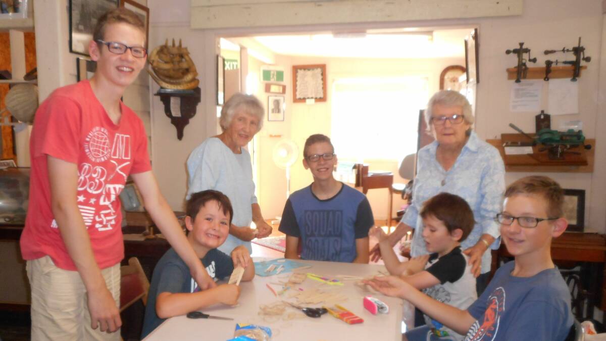 The Cork family and volunteer Anne Gray at the “No Batteries Required” activities organised by Nambucca Headland Museum volunteers during the school holidays.
