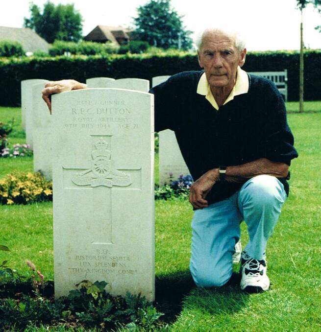During a visit to Normandy in 2003 Ken pays his respects at the grave of his mate Bob Dutton.