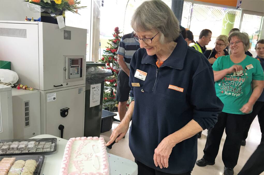 Kay cutting her cake at a special retirement morning tea at Foodworks.