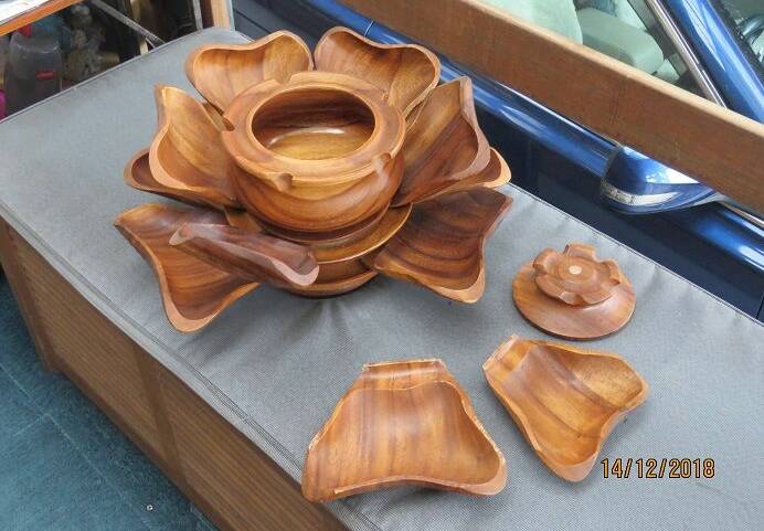 The wood turned bowl and the lid with two carved petals/plates detatched.
