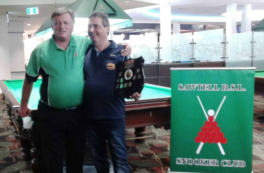 Macksville Snooker club president Selwyn Branford receiving the winning shield from Sawtell president Darrell Wallbridge at the inter-club snooker competition at Sawtell on Sunday, September 8. Photo supplied.