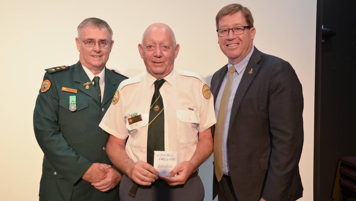 FORTY MIGHTY YEARS OF SERVICE: Christopher Pearson receives his award at the annual VRA conference held in Dubbo. He is pictured here with Commissioner Mark Gibson, left, and Troy Grant, Minister for Emergency Services and Police
