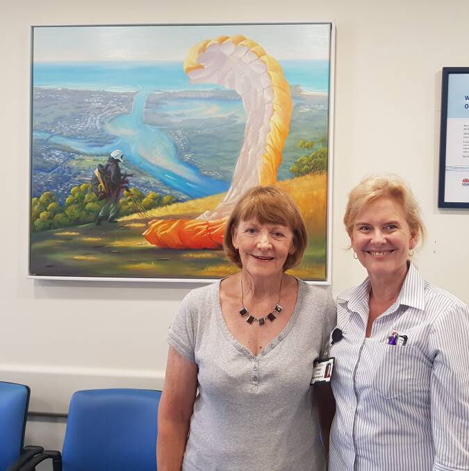 Artist Jan Wilson and Nursing Unit Manager Jenny Baroutis with the painting commissioned by the Mid North Coast Machinery Restoration Club.