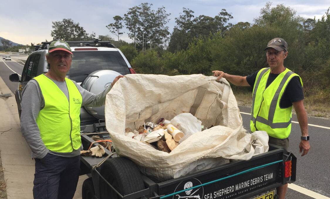 CLEANING UP: Darren Squibb (right) and 'Tagalong' Tim took forty minutes to gather all this rubbish from the Nambucca Heads Service Centre exit ramp