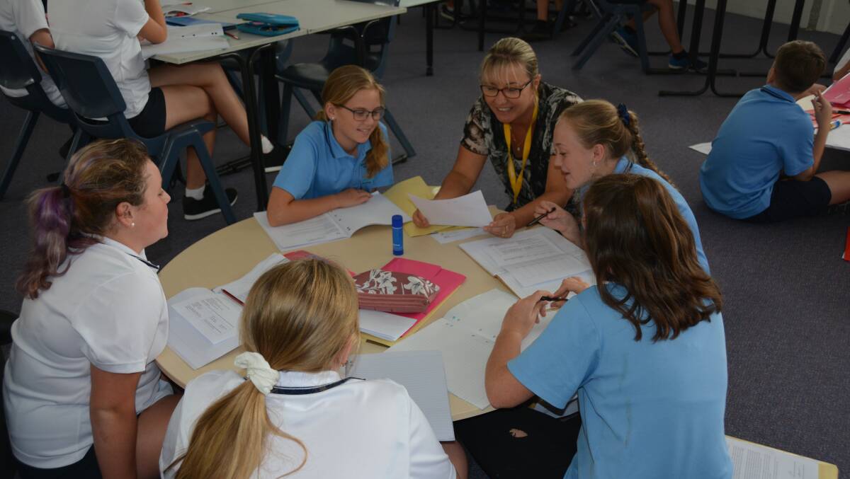 HUDDLING DOWN: Teacher Danielle Bowen with a group of Year 7 students at Nambucca Heads High School