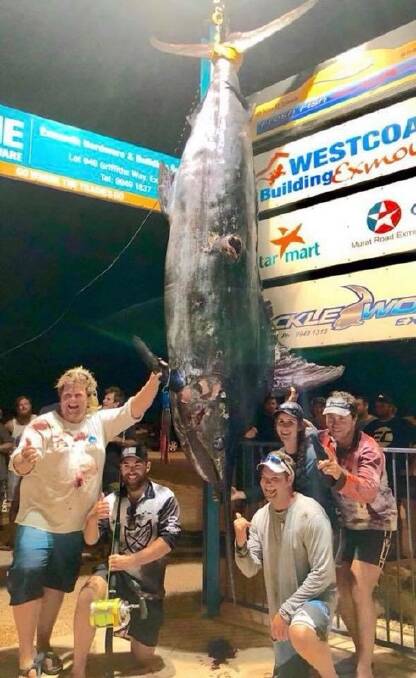 WINNING COMBINATION: From left, Skipper Eddy Lawler, Clay Hilbert, Hayley Dellar, Leigh Freestone and Wes Jones (kneeling) with the 494 kg blue marlin
