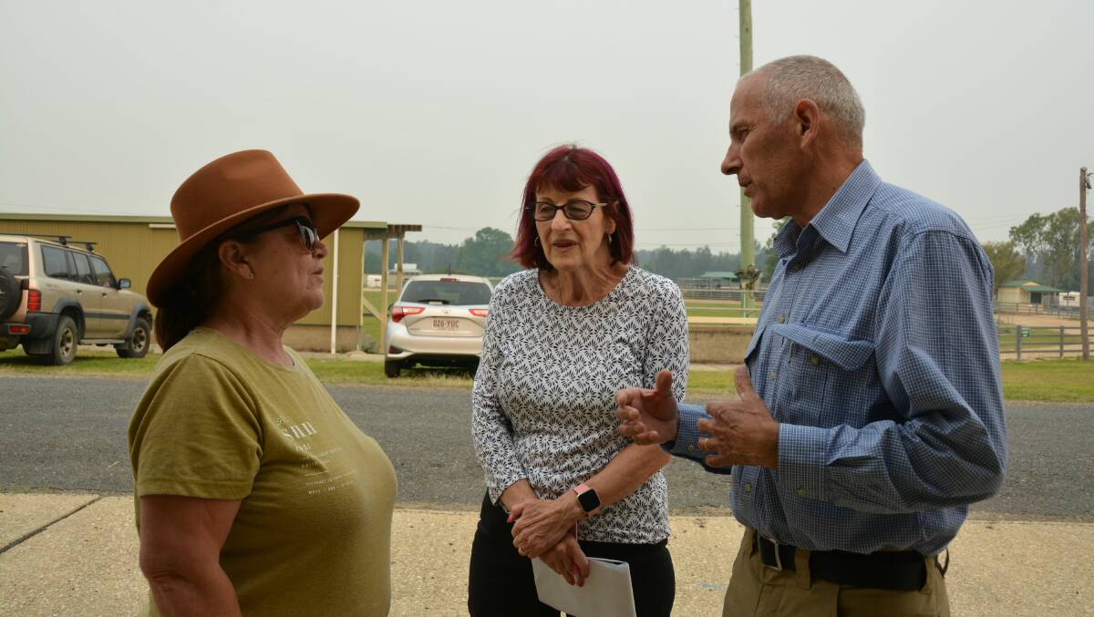 NSW Recovery Coordinator Euan Fergusan and assistant Ronnie Faggotter talk to Taylors Arm evacuee Jan Roberton