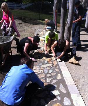 BLOSSOMING PARTNERSHIP: Students creating the pathways for the bushtucker garden