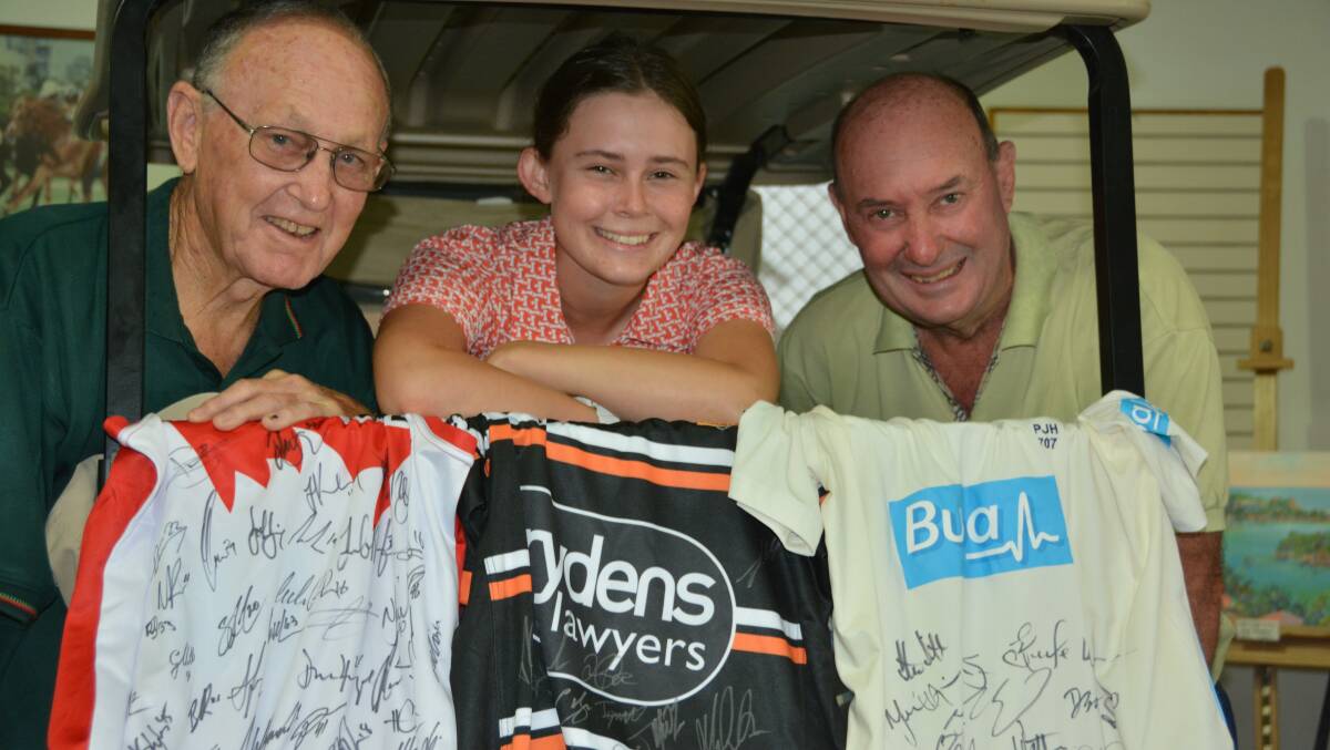 DOING IT FOR ELLY: Ray Stig and best mate Wayne Bolton with Nambucca Heads golfer Darcy Habgood plus some of this year's great collection of raffle treats