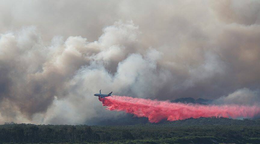 737 large air tanker dropping fire retardant on the fire north of Crescent Head on Saturday August 10. Photo: Heather Matthews