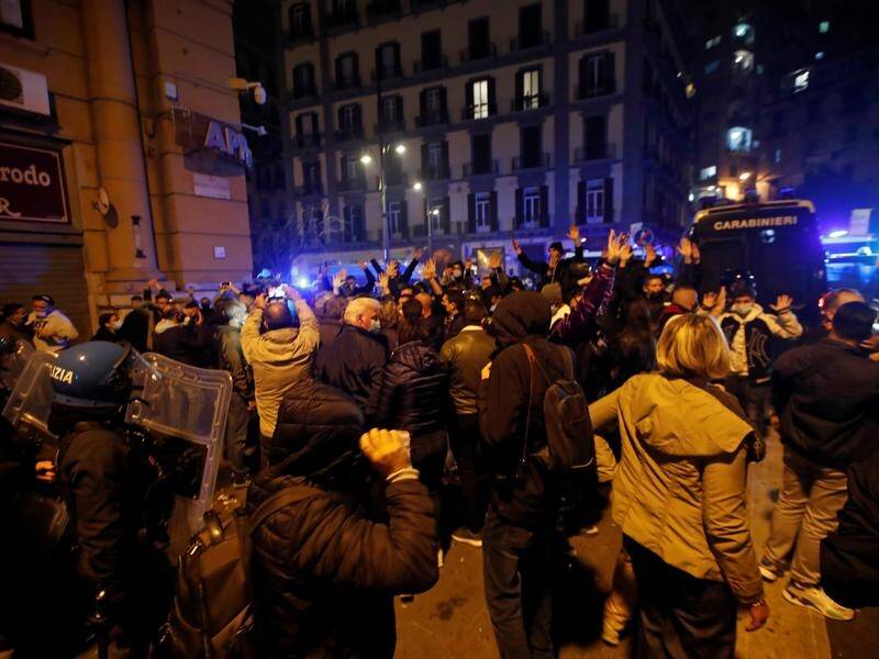People protest after authorities in Campania imposed a curfew to curb a coronavirus surge in Naples.