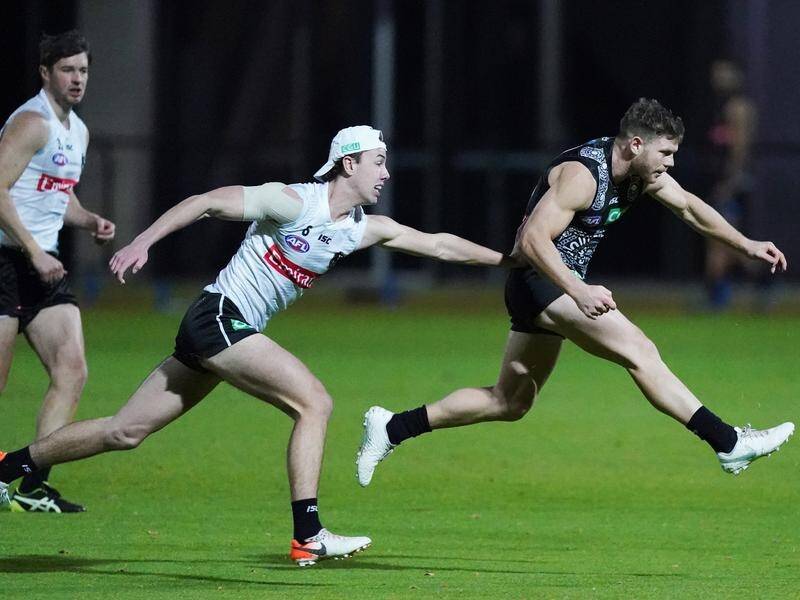 Collingwood midfielder Taylor Adams (r) says possible further AFL job losses are a major concern.