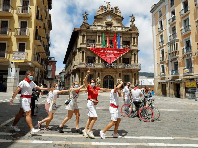 Revellers by the town hall in Pamplona where the bull running festival is cancelled this year.