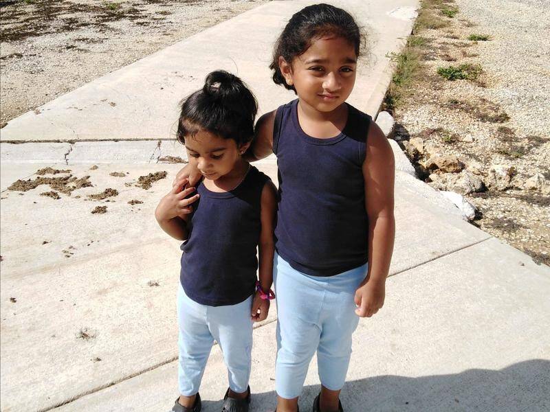 Kopika (right) and Tharunicaa have been on Christmas Island for more than a year.