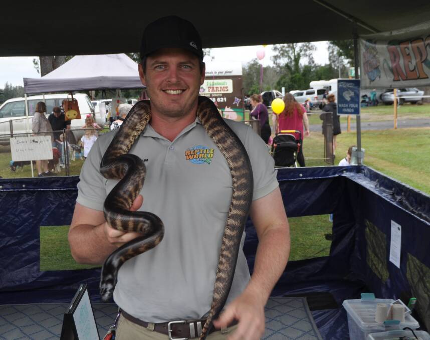 Adam Strickland from Steve McEwan's Reptile World with 'Buddy' the black-headed python. Photo: Stephen Katte 
