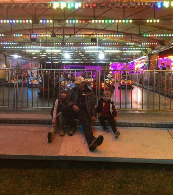 Bella Mason, Lee Laverty and Oscar Mason in front of the dodgem car track. Photo: Supplied 