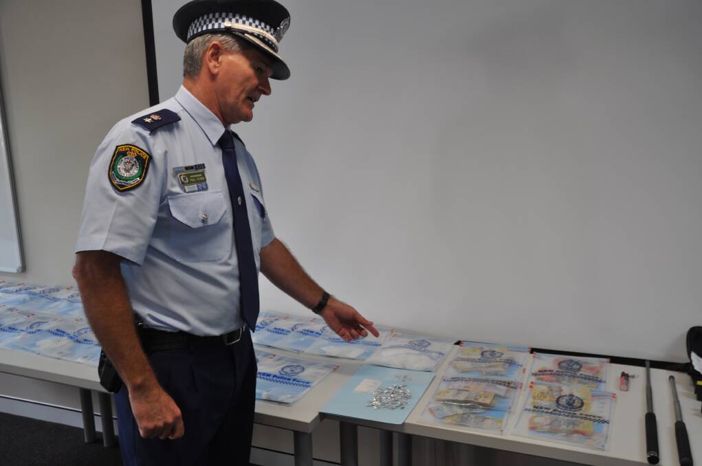 Mid North Coast Local Area Commander Superintendent Paul Fehon with the drugs, weapons and seized cash. Photo: Stephen Katte 