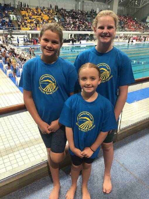 GIRL POWER: Keeley Sutton, Jazmin Sutton. Front: Lily Riddington were given Swimming North Coast shirts and caps to wear throughout the meet. Photo: Supplied