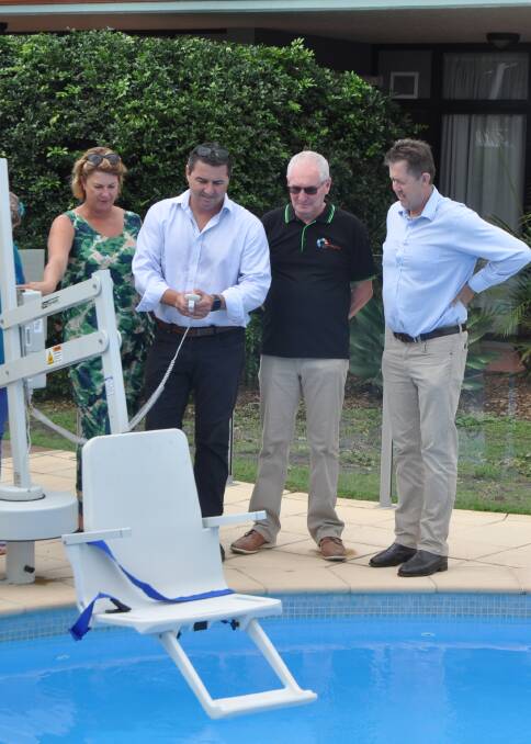 Member for Oxley Melinda Pavey, candidate for Cowper Pat Conaghan, CEO of the FCSWC Ken Conway and Member for Cowper Luke Hartsuyker inspecting the pool hydro-lift today