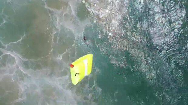 The drone dropped the flotation device to the swimmers.  Photo: NSW GOVERNMENT