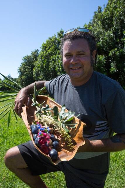 RICH HARVEST: Clayton with foods he harvested from a native forest on a flourishing macadamia farm.