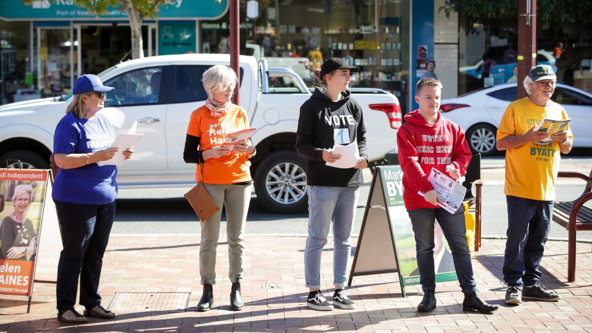COLOURS OF THE CAMPAIGN: Candidates and volunteers handing out how to vote cards this week in the seat of Indi formerly held by independent Cathy McGowan