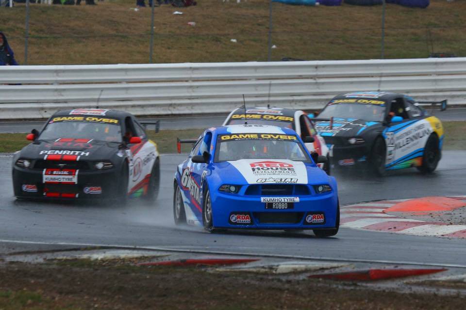 Frederickton's Jaie Robson in his blue 98 Mustang leads the field around a bend at the Symmons Plains Track in Hobart in round 2 of the Aussie Racing Car Championships.