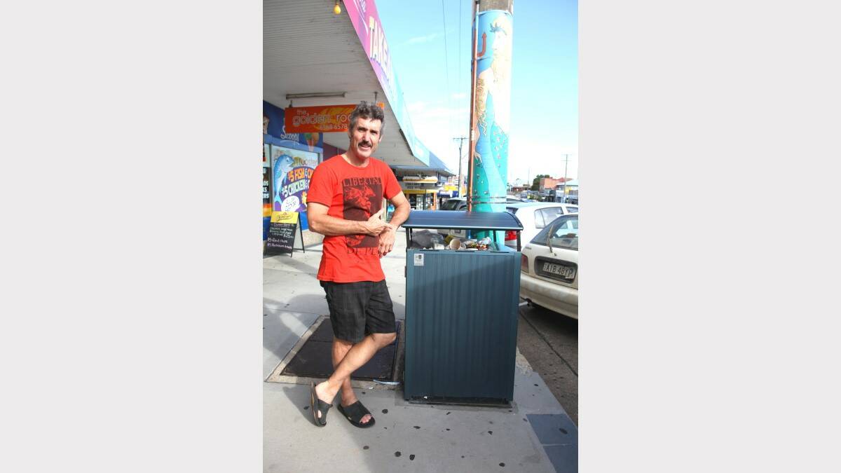 LESS THAN IMPRESSED: Richard Ellis points to an overfull bin in Bowra St, Nambucca Heads.
